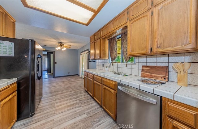 43096 Deer Trail Way, Coarsegold, CA 93614 - kitchen with dishwasher, black fridge with ice dispenser, a sink, tasteful backsplash, and tile countertops