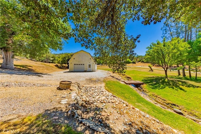 43096 Deer Trail Way, Coarsegold, CA 93614 - view of grassy yard with an outbuilding, a garage, and a barn