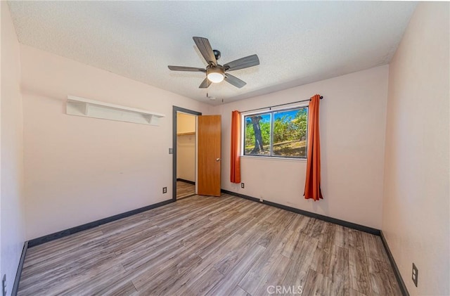 43096 Deer Trail Way, Coarsegold, CA 93614 - spare room with wood finished floors, a ceiling fan, baseboards, and a textured ceiling