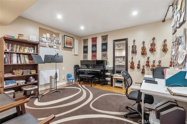 home office with recessed lighting, wood finished floors, and baseboards