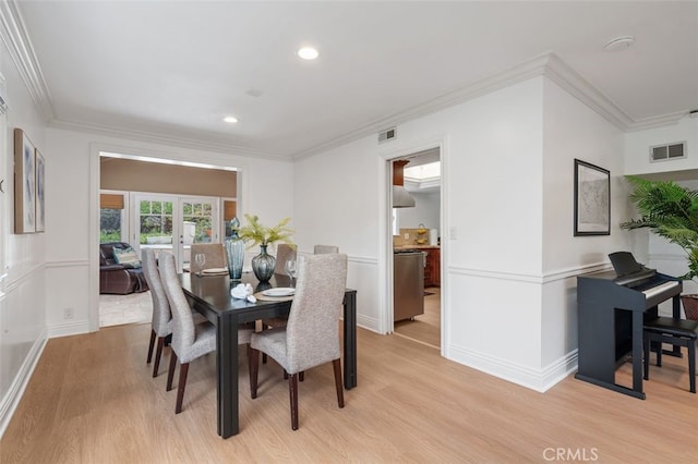 dining area with light wood-style floors, crown molding, recessed lighting, baseboards, and french doors