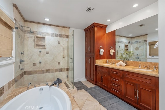 bathroom featuring a stall shower, a garden tub, double vanity, recessed lighting, and tile patterned flooring