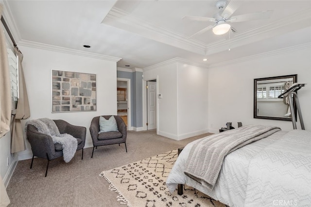 bedroom featuring crown molding, a tray ceiling, light carpet, baseboards, and a ceiling fan