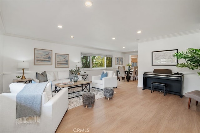 living area featuring crown molding, recessed lighting, and light wood-style floors