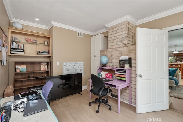 home office featuring light wood-style floors, crown molding, and baseboards