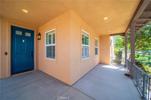 3933 E Bethany Way, Ontario, CA 91761 - doorway to property featuring a porch and stucco siding
