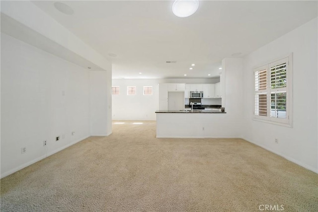 3933 E Bethany Way, Ontario, CA 91761 - unfurnished living room featuring light carpet, recessed lighting, and baseboards
