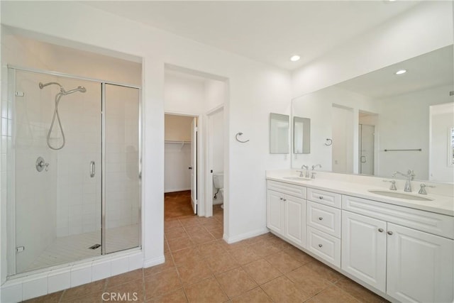 3933 E Bethany Way, Ontario, CA 91761 - bathroom with a shower stall, tile patterned floors, double vanity, recessed lighting, and baseboards