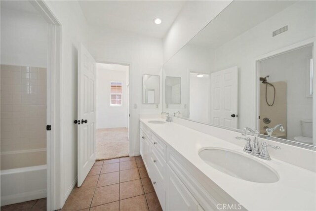 3933 E Bethany Way, Ontario, CA 91761 - bathroom with tile patterned flooring, toilet, double vanity, and recessed lighting