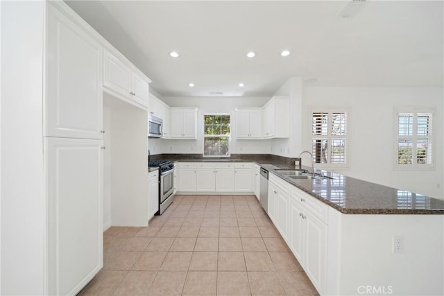 3933 E Bethany Way, Ontario, CA 91761 - kitchen with appliances with stainless steel finishes, a peninsula, light tile patterned flooring, a sink, and recessed lighting