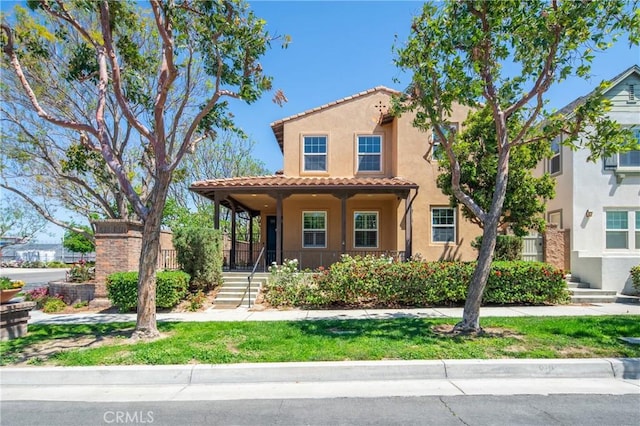 3933 E Bethany Way, Ontario, CA 91761 - mediterranean / spanish house featuring a tile roof, stucco siding, and covered porch
