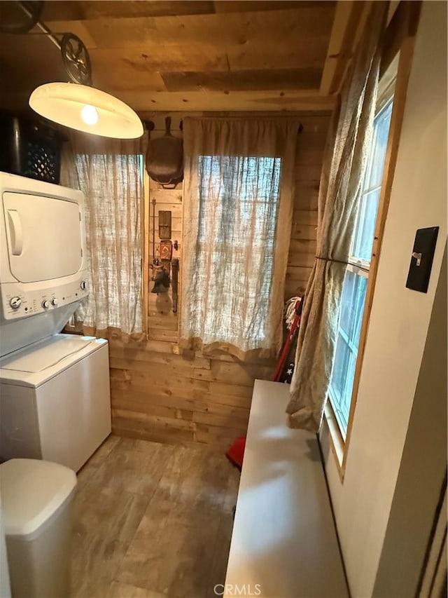 23739 Skyland Dr, Crestline, CA 92325 - clothes washing area featuring stacked washer / dryer, wood ceiling, and wood finished floors