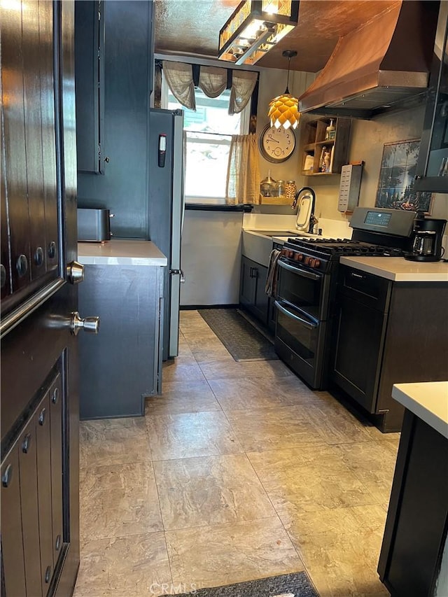 23739 Skyland Dr, Crestline, CA 92325 - kitchen featuring range with two ovens, wall chimney exhaust hood, light countertops, a sink, and freestanding refrigerator