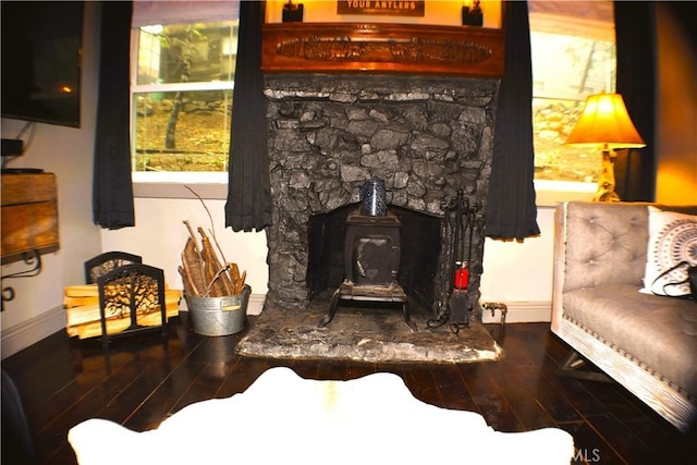 23739 Skyland Dr, Crestline, CA 92325 - living area featuring a wood stove, wood finished floors, and baseboards
