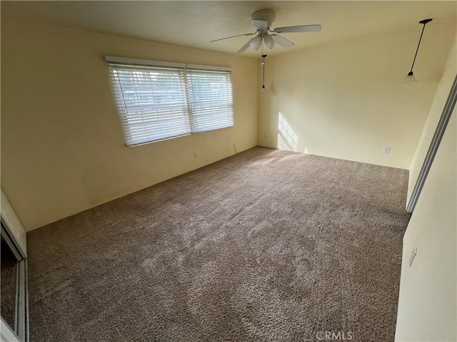 carpeted empty room with ceiling fan