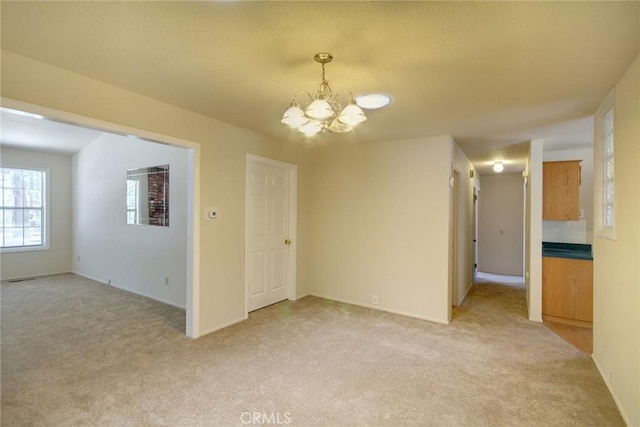 221 E Barker Blvd, Big Bear City, CA 92314 - spare room with a chandelier, light carpet, and baseboards