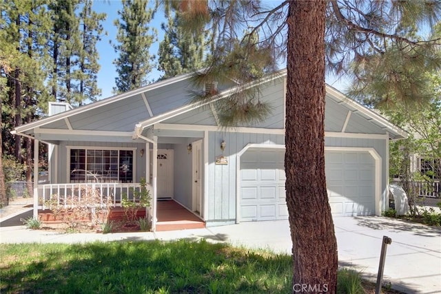 221 E Barker Blvd, Big Bear City, CA 92314 - view of front of property with an attached garage, concrete driveway, and a porch