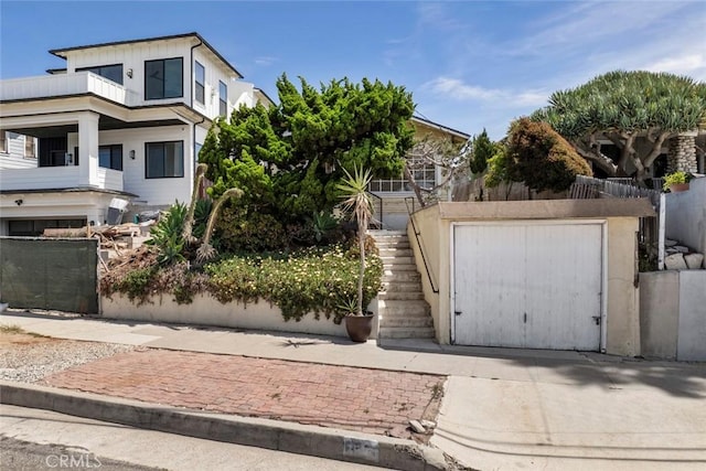 808 El Redondo Ave, Redondo Beach, CA 90277 - view of front of house featuring stairway, a balcony, fence, and an outdoor structure