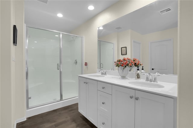 30853 Pony Express Dr, Winchester, CA 92596 - bathroom featuring a stall shower, wood finished floors, double vanity, and recessed lighting