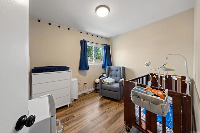 9560 Frank Way, Santee, CA 92071 - bedroom with wood finished floors and a nursery area