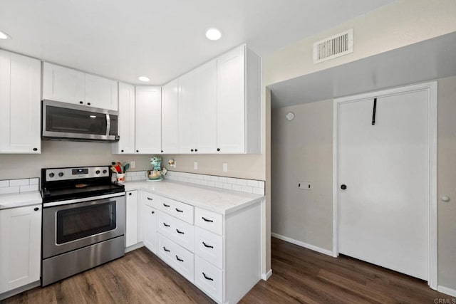 9560 Frank Way, Santee, CA 92071 - kitchen with appliances with stainless steel finishes, dark wood-type flooring, recessed lighting, and white cabinets