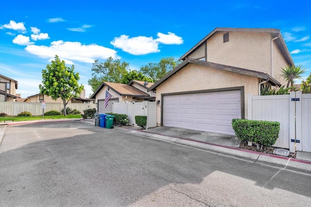 9560 Frank Way, Santee, CA 92071 - view of front of property featuring a gate, stucco siding, a garage, and fence