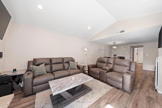 9560 Frank Way, Santee, CA 92071 - living room with lofted ceiling, light wood-style floors, and a chandelier