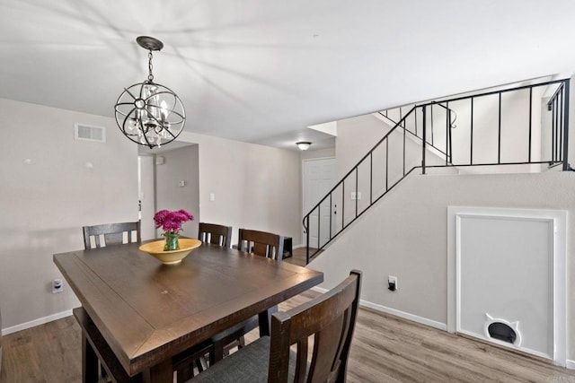 9560 Frank Way, Santee, CA 92071 - dining room with a chandelier, light wood-style flooring, and stairway
