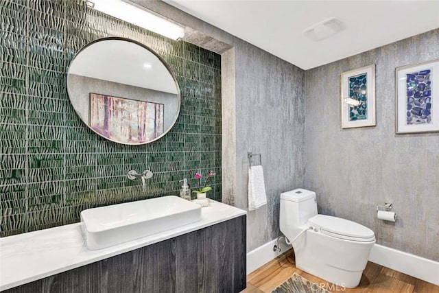 18782 Peppertree Dr, Villa Park, CA 92861 - bathroom with tile walls, toilet, a sink, wood finished floors, and baseboards