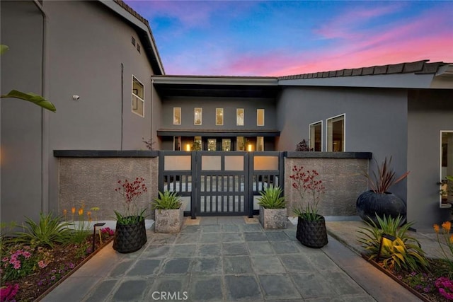 18782 Peppertree Dr, Villa Park, CA 92861 - exterior entry at dusk with stucco siding