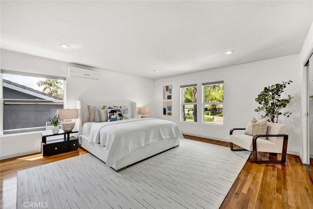 18782 Peppertree Dr, Villa Park, CA 92861 - bedroom with a wall unit AC, wood finished floors, recessed lighting, and baseboards