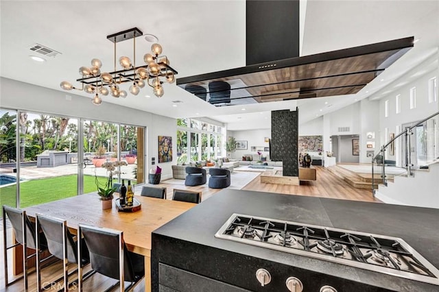18782 Peppertree Dr, Villa Park, CA 92861 - kitchen with a chandelier, recessed lighting, stainless steel gas cooktop, open floor plan, and wood finished floors