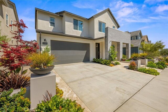 32404 Old Sage Dr, San Juan Capistrano, CA 92675 - view of front facade featuring an attached garage, stucco siding, and driveway