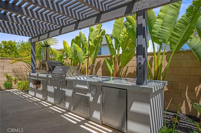 32404 Old Sage Dr, San Juan Capistrano, CA 92675 - view of patio featuring exterior kitchen, fence, grilling area, a pergola, and a sink