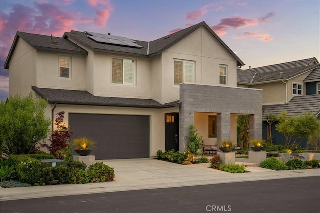 32404 Old Sage Dr, San Juan Capistrano, CA 92675 - view of front of property with roof mounted solar panels, stucco siding, an attached garage, and driveway