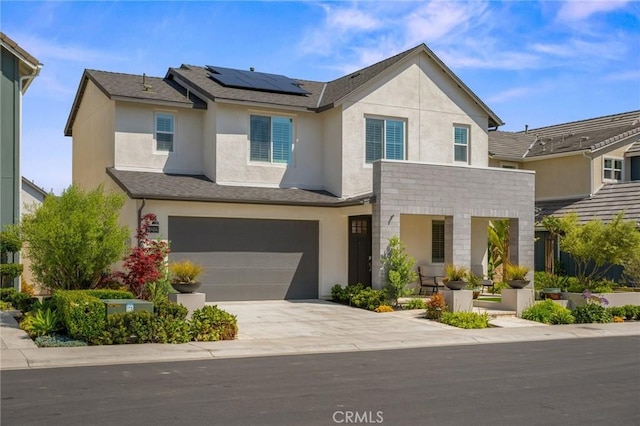 32404 Old Sage Dr, San Juan Capistrano, CA 92675 - view of front of home with stucco siding, roof mounted solar panels, a garage, concrete driveway, and stone siding
