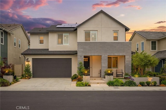 32404 Old Sage Dr, San Juan Capistrano, CA 92675 - view of front of home featuring solar panels, an attached garage, concrete driveway, stucco siding, and covered porch