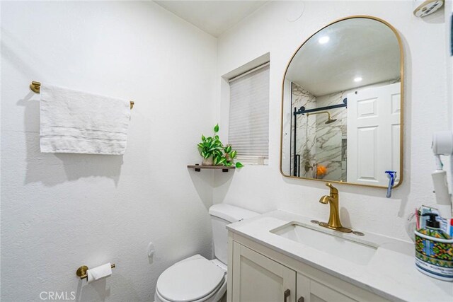 365 W Alameda Ave Unit 203, Burbank, CA 91506 - bathroom featuring a marble finish shower, toilet, and vanity