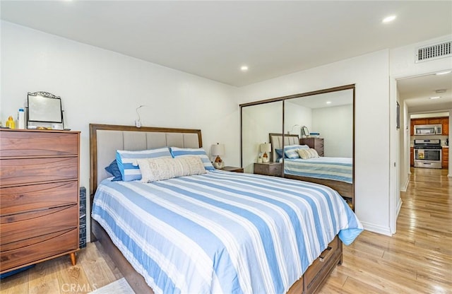 365 W Alameda Ave Unit 203, Burbank, CA 91506 - bedroom with light wood-style flooring, a closet, and recessed lighting