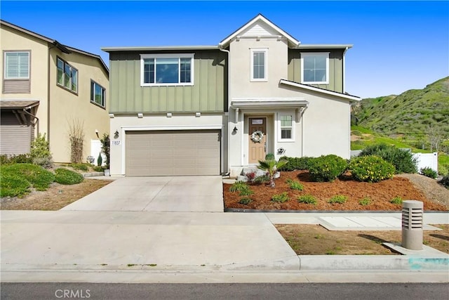 11837 Terra Vista Way, Sylmar, CA 91342 - traditional-style house with board and batten siding, driveway, a garage, a mountain view, and stucco siding