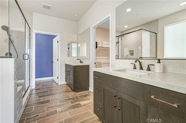 11837 Terra Vista Way, Sylmar, CA 91342 - full bath featuring a shower stall, two vanities, wood finish floors, baseboards, and recessed lighting
