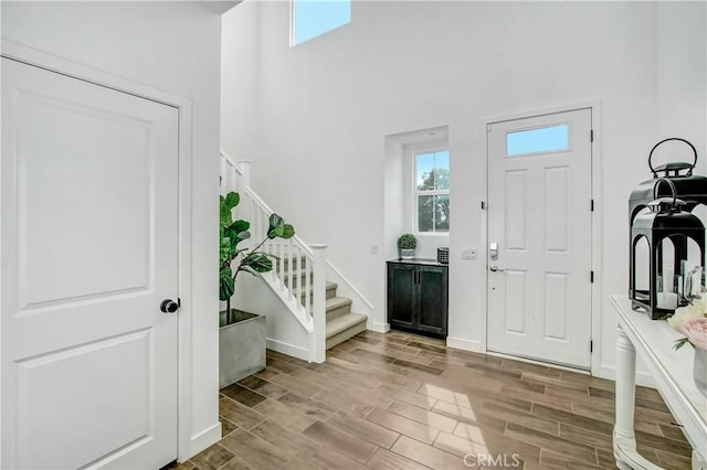 11837 Terra Vista Way, Sylmar, CA 91342 - foyer entrance featuring stairs, a towering ceiling, wood finished floors, and baseboards