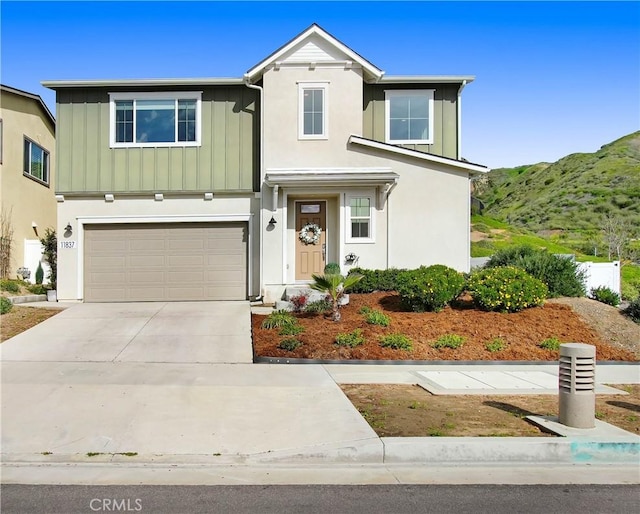 11837 Terra Vista Way, Sylmar, CA 91342 - traditional-style house with board and batten siding, driveway, a garage, and a mountain view