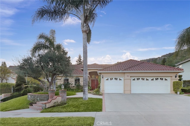 24632 Stagg St, West Hills, CA 91304 - mediterranean / spanish-style house featuring driveway, an attached garage, a front lawn, stucco siding, and a tiled roof