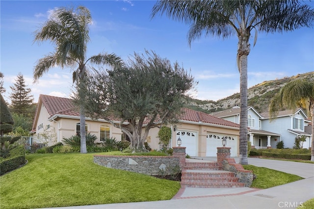 24632 Stagg St, West Hills, CA 91304 - view of front of home featuring an attached garage, stucco siding, a tile roof, a front lawn, and concrete driveway