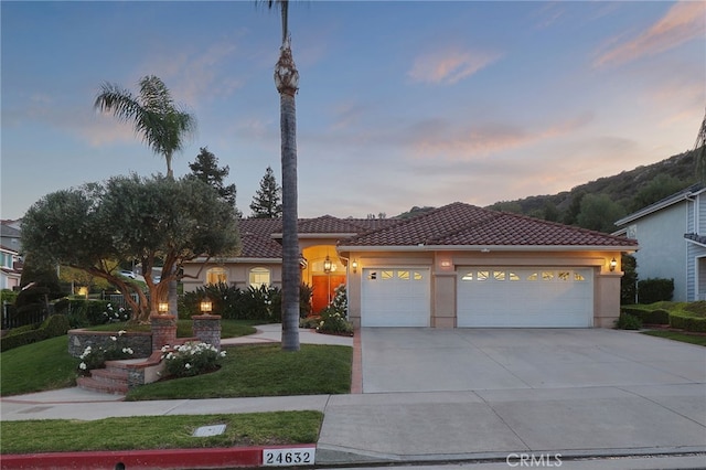 24632 Stagg St, West Hills, CA 91304 - mediterranean / spanish-style home featuring concrete driveway, a garage, a tiled roof, stucco siding, and a lawn