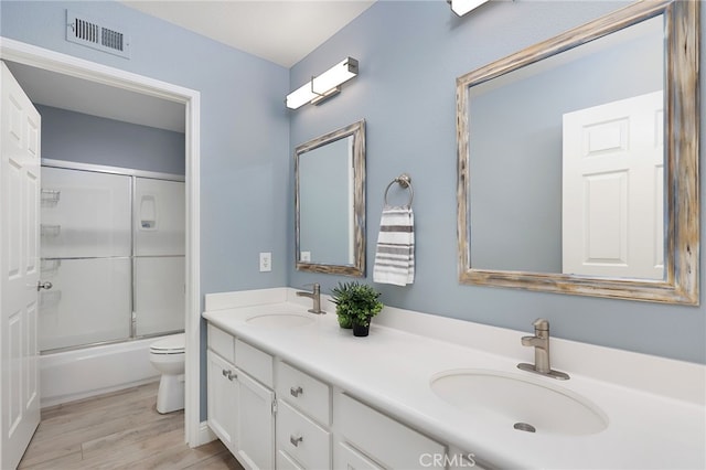 24632 Stagg St, West Hills, CA 91304 - full bathroom featuring double vanity, wood finished floors, and enclosed tub / shower combo