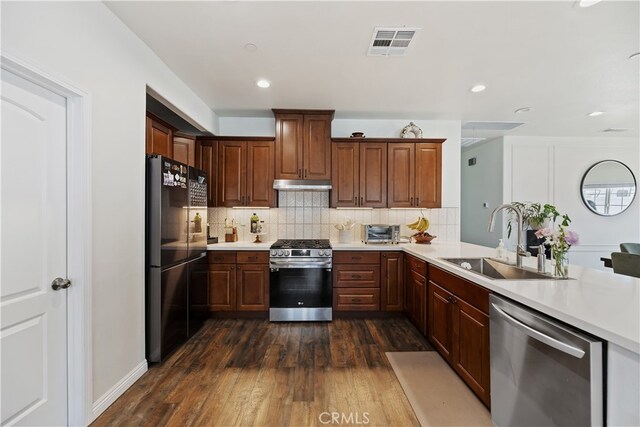 23900 Vista Way, Menifee, CA 92587 - kitchen featuring appliances with stainless steel finishes, a sink, light countertops, dark wood finished floors, and recessed lighting