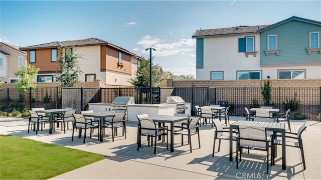 30051 Sunset Pier Dr, Menifee, CA 92584 - view of patio featuring an outdoor kitchen, fence, outdoor dining space, and grilling area