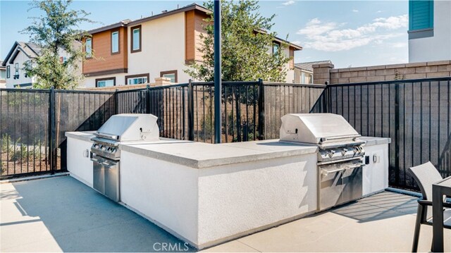 30051 Sunset Pier Dr, Menifee, CA 92584 - view of patio featuring an outdoor kitchen, a fenced backyard, and grilling area